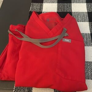 Red figs scrubs. Pants are straight legged. Both top and bottoms are xxs.